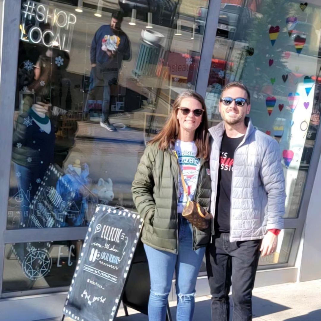 Elliot and Maria Pfarr of Pfarrside Creations standing in front of Eclectic CO. in Downtown Colorado Springs.